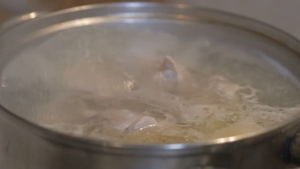 On a gas stove is cooked in the pot soup. the broth is boiling, brewing. beautiful shot with soft focus. — Stock Video