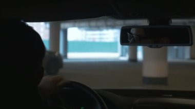 Yeraltı Otopark, arabayı kullanan bir adam. Yakın çekim. Bokeh arka plan