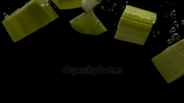 Vegetables falling into water on black background. Bright high quality video. — Stock Video