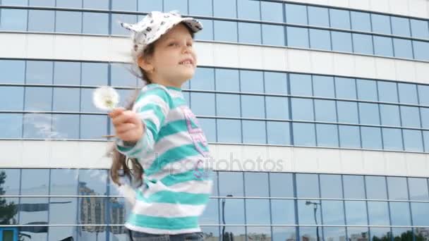 A child plays in the Park with dandelions — Stock Video