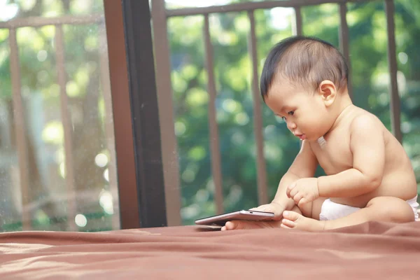 Asian baby playing mobile phone — Stock Photo, Image