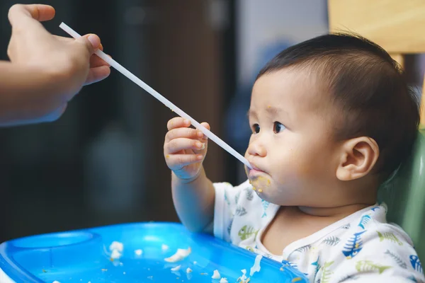 Asian baby drinking through straw — Stock Photo, Image