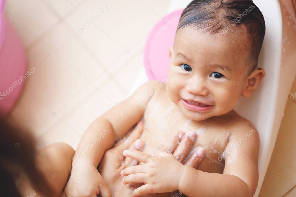 11 months Asian baby bathing