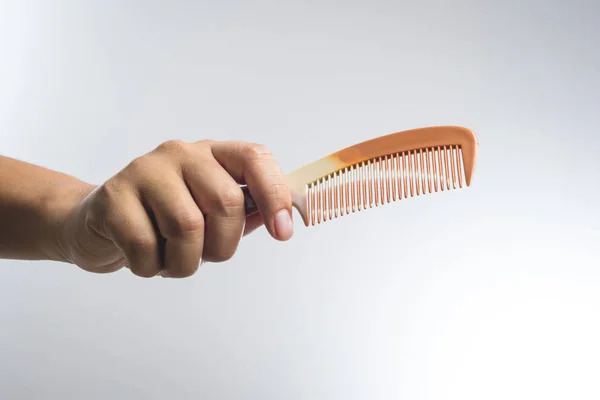 Hand holding rubber comb — Stock Photo, Image