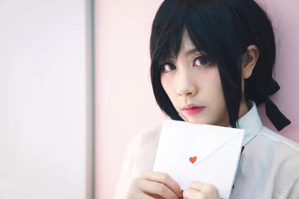 Asian girl in uniform with love letter — Stock Photo, Image