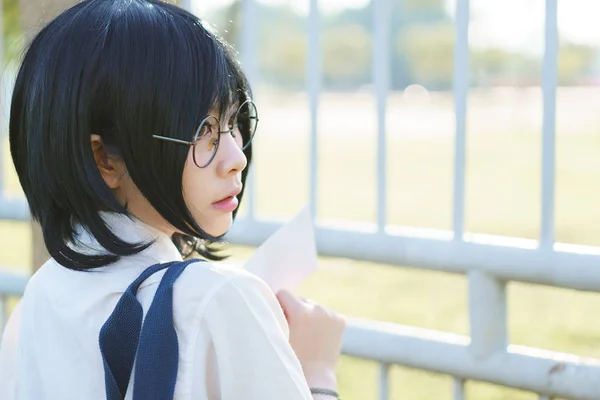 Asiatisk tjej i uniform med kärleksbrev — Stockfoto