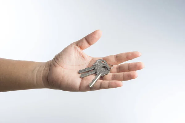 Hand giving keys — Stock Photo, Image