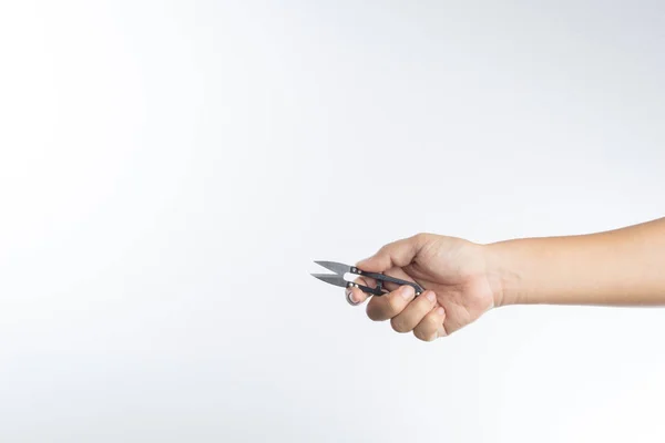 Hand holding thread scissors — Stock Photo, Image