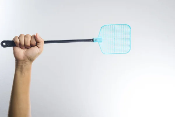 Hand holding fly or insect swatter — Stock Photo, Image