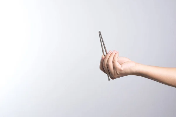 Hand holding stainless chop stick — Stock Photo, Image