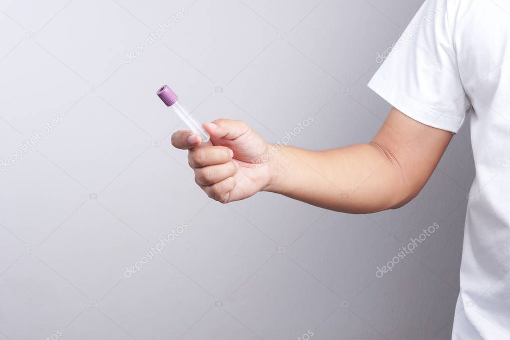 Hand holding empty test tube