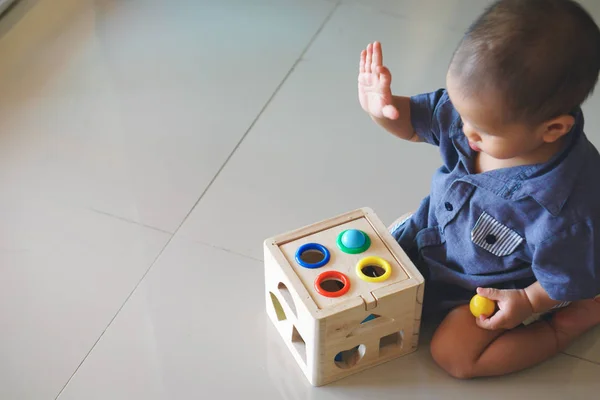 Asian baby playing wooden toy box — Stock Photo, Image