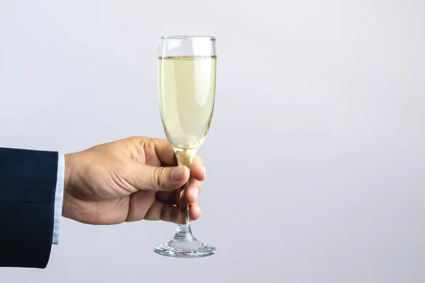 Business man hand holding glass of champagne for celebration — Stock Photo, Image