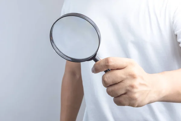 Hand holding magnifier — Stock Photo, Image