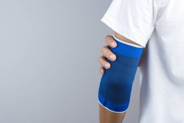 Arm with elastic elbow support and hurt gesture clipart
