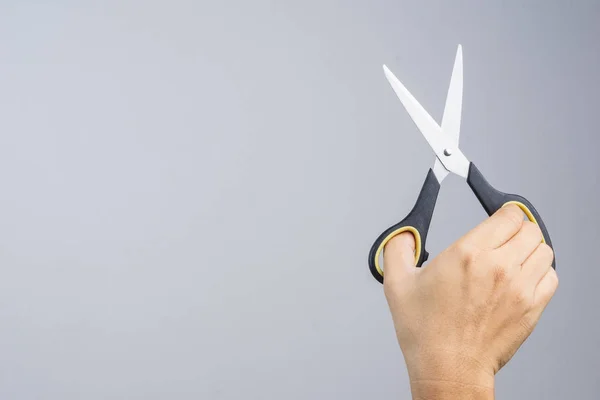 Hand holding office scissors — Stock Photo, Image