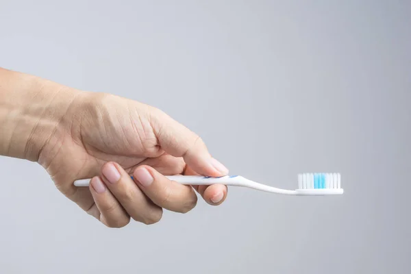 Hand holding clean and new toothbrush — Stock Photo, Image