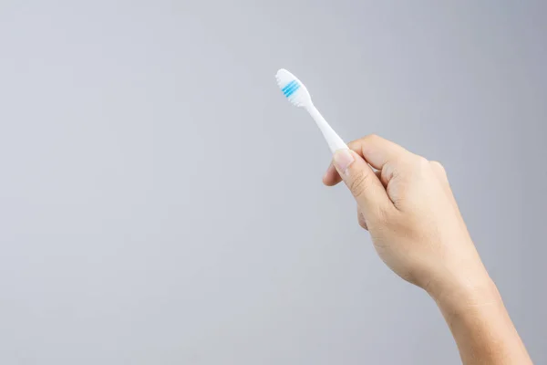 Hand holding clean and new toothbrush — Stock Photo, Image
