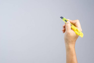 Office sarı kağıt kesici tutan el