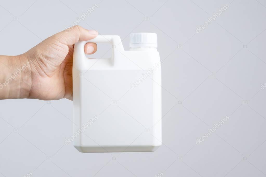 Hand holding 1000 cc, a liter plastic bottle or 0.26 gallon capa