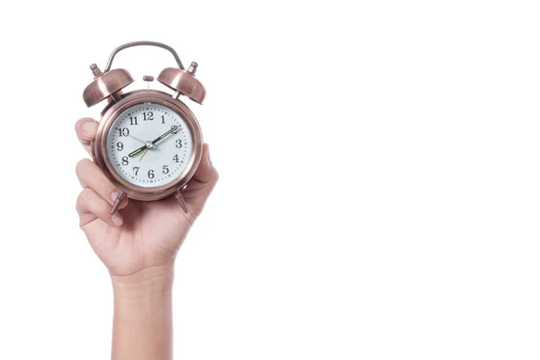 Tangan memegang jam alarm antik pengaturan pukul 7 pagi dan menunjukkan waktu — Stok Foto