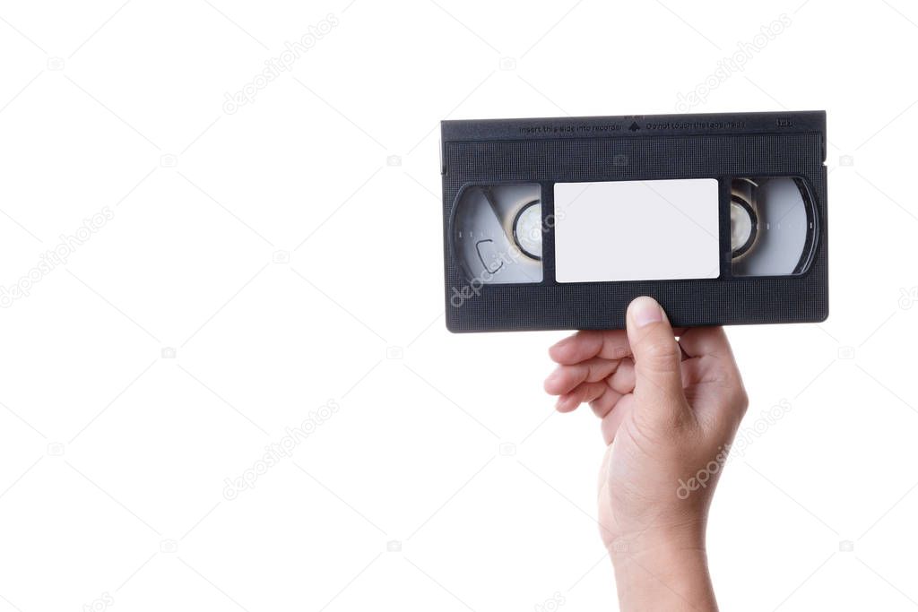 Hand holding old analog VHS Video Cassette Tape on white background