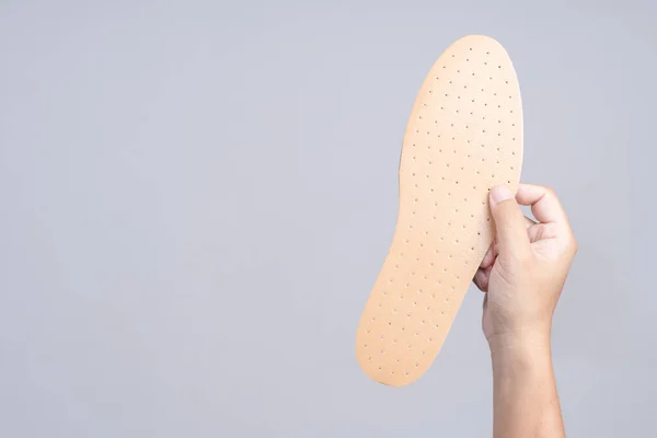 Hand holding replacement shoe sole — Stock Photo, Image