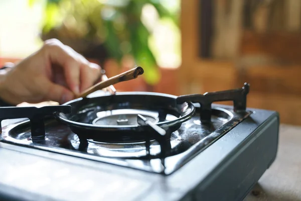 Grill cinnamon stick on portable stove