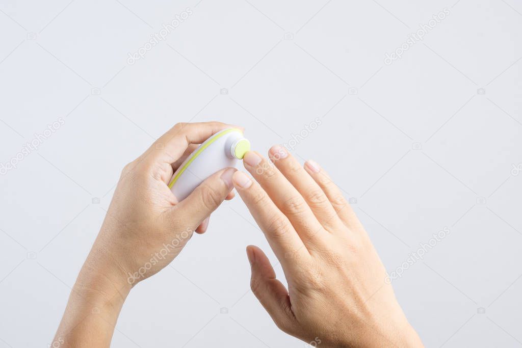 Hand holding finger nails cutter buffing or polishing kit for ki