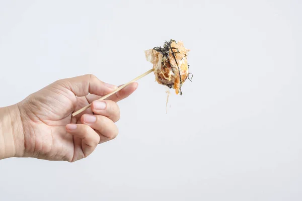 Mão segurando Takoyaki, uma bola de farinha cheia de polvo, Japane — Fotografia de Stock