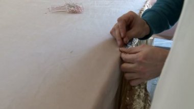 Dekoratör tablo parlak kumaş ile donatır.