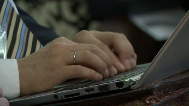 Close-up of man typing on laptop keyboard — Stock Video