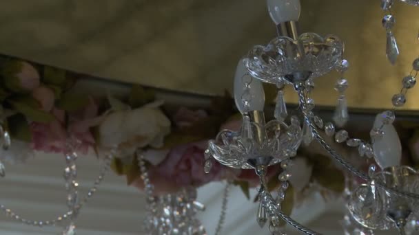 Close-up of crystal chandelier swayed — Stock Video
