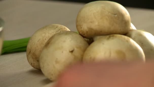 Man cutting mushroom in the kitchen with knife — Stock Video