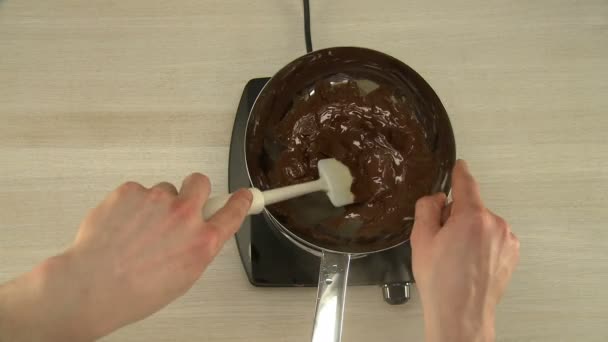 Chocolate glaze on stove mixing process — Stock Video