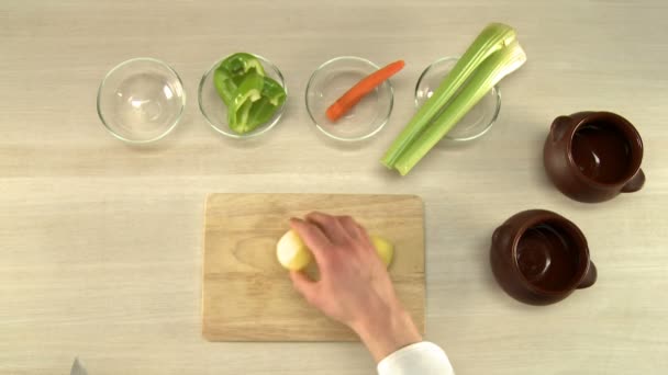 Cuisinière coupant les pommes de terre sur plateau en bois vue dessus — Video