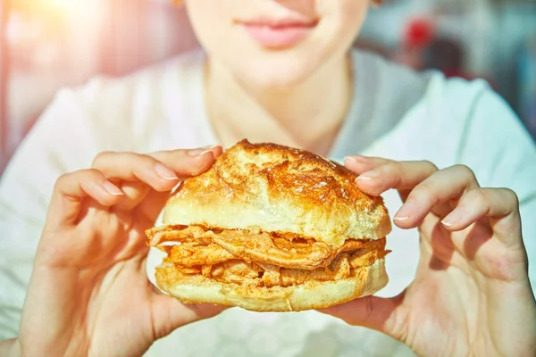 Woman eating traditional portuguese pork beef sandwich bifana . Traditional Portuguese food