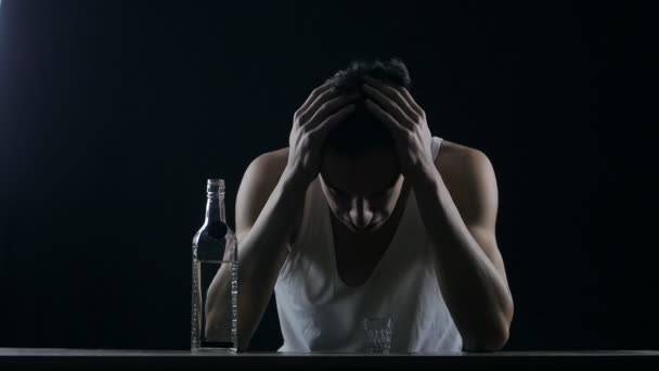 Depressed man crying with a bottle of vodka. man in despair — Stock video