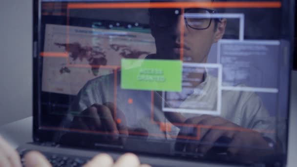 Man working at a laptop in the reflection of the monitor — Stock Video