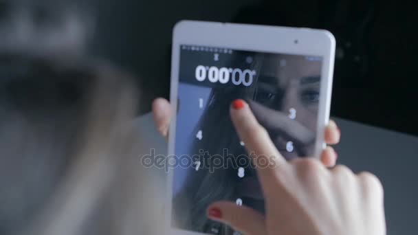 Double exposure shot of woman working on digital tablet in dark room — стоковое видео