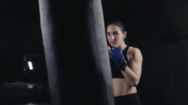 Kickboxerin trainiert Boxsack im Fitnessstudio — Stockvideo