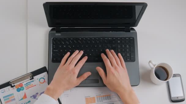 Επιχειρηματίας που εργάζεται στο γραφείο με ένα φορητό υπολογιστή, tablet, smartphone και άλλα εργαλεία εργασίας — Αρχείο Βίντεο
