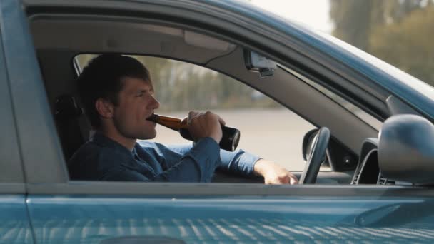 Un hombre bebiendo cerveza en el coche. Conductor borracho — Vídeos de Stock