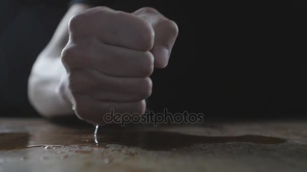 Чоловік б'є кулаком на мокрий стіл, демонструючи агресію. Поняття жорстокості . — стокове відео