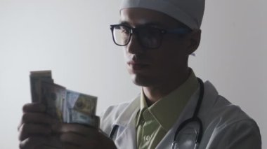 Doktor para sayar. Tıbbi bir işçi için rüşvet. Pahalı ilaç.