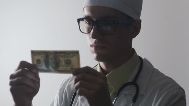 The doctor kisses a 100 dollar bill. A bribe to a medical worker. Expensive medicine.