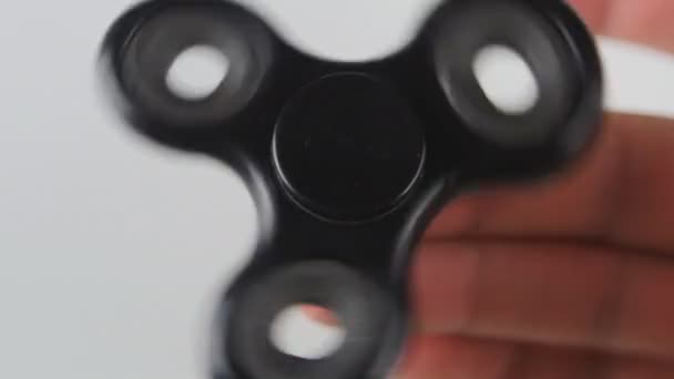 Spinner or fidgeting hand toy rotating on mans hand — Stock Video
