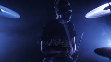 Davulcu maskesi ile sahnede konser rock bant. Müzik video punk, ağır metal veya rock grubu. Yavaş hareket saz