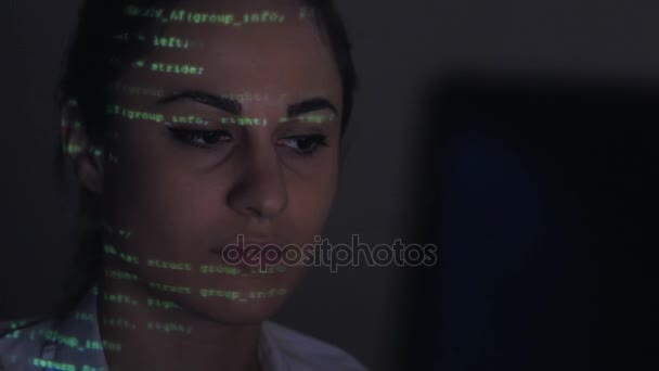 Young women scrubbing trough computer code. Female face with binary code projections — Stock Video