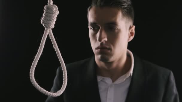 Самоубийство. несчастный бизнесмен на фоне петли для шеи — стоковое видео